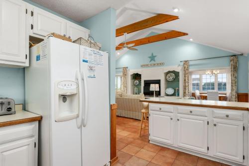 a kitchen with white cabinets and a white refrigerator at DK347 "Ehh, Whats up, Duck" in Duck