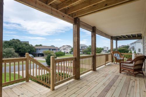 a wooden deck with a view of a yard at DK347 "Ehh, Whats up, Duck" in Duck
