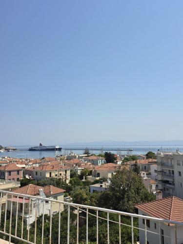 a view of a city with buildings and the ocean at Your refuge overlooking port 6A in Mesochórion