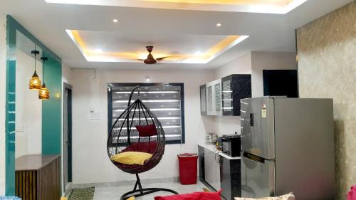 a room with a hanging chair in a kitchen at Venya Vihar a Deluxe 2 BHK Home Stays in Visakhapatnam