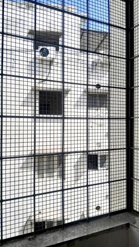 a cage with three white dogs in it at Venya Vihar a Deluxe 2 BHK Home Stays in Visakhapatnam