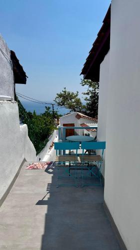 a blue table and chairs sitting on a patio at Old soul, Sea views in Dhërmi