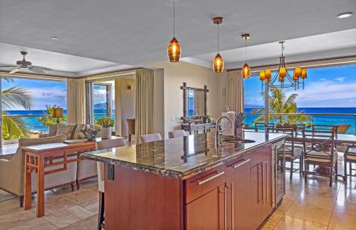 a kitchen and living room with a view of the ocean at Honua Kai Resort And Spa By Maui Resort Rentals in Lahaina