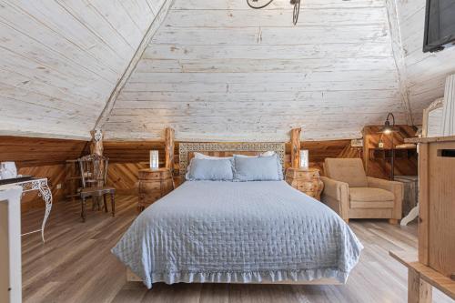 a bedroom with a bed in a room with wooden walls at NINHO SALOIO in Venda do Pinheiro