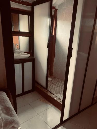 a bathroom with a mirror and a sink at Semper Fidelis Camp in Solferino 