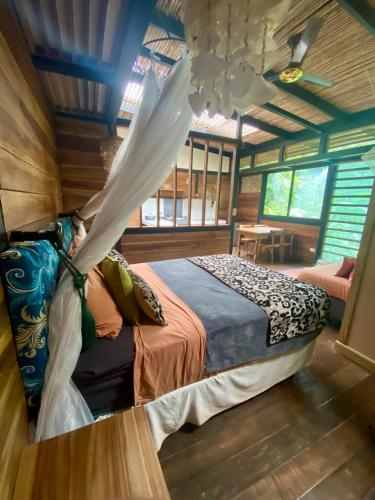 a bedroom with a bed in a wooden house at La Shamana - Ecological Concept in Jungle in Cahuita