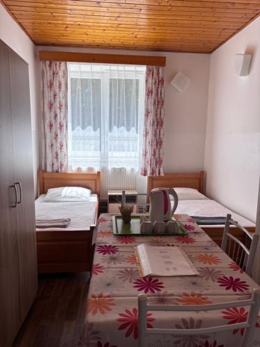 a small room with two beds and a window at Ubytování Přimda in Přimda
