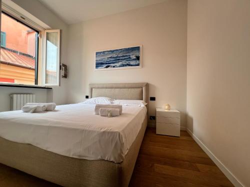 une chambre avec un lit et une fenêtre dans l'établissement WELCOME RIVIERA - ORO Apartment, 2Bedroom, 2Bathroom Apartment with Free Garage at 800 mt, Lift, Shared Terrace, Balcony, Wi-Fi, Air Conditioning, The Ideal Choice for a Relaxing and Exciting Coastal Escape, à Rapallo