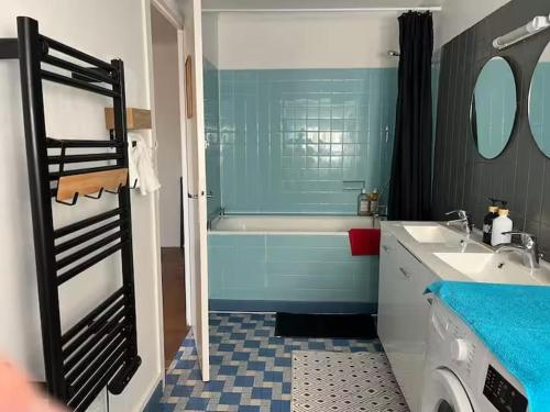 a blue bathroom with a tub and a sink at Comptoir du Golf Studio in Villedieu-sur-Indre