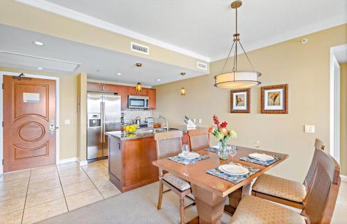 a dining room and kitchen with a table and chairs at Honua Kai Resort And Spa By Maui Resort Rentals in Lahaina