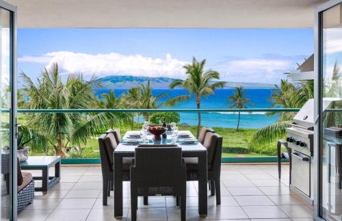 a dining room with a table and a view of the ocean at Honua Kai Resort And Spa By Maui Resort Rentals in Lahaina