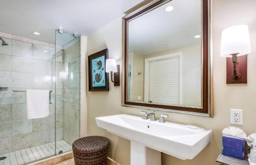 a bathroom with a sink and a shower at Honua Kai Resort And Spa By Maui Resort Rentals in Lahaina