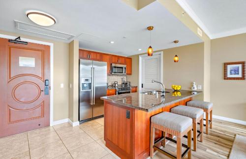 a kitchen with a large island with bar stools at Honua Kai Resort And Spa By Maui Resort Rentals in Lahaina