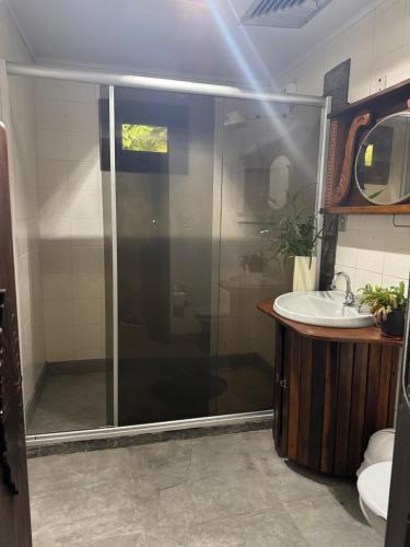 a bathroom with a shower and a sink at Casa da Oma in Blumenau