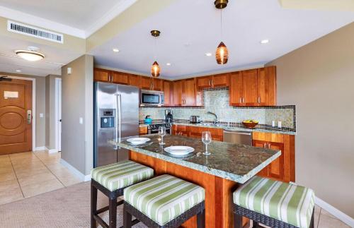 a kitchen with a large island with bar stools at Honua Kai Resort And Spa By Maui Resort Rentals in Lahaina