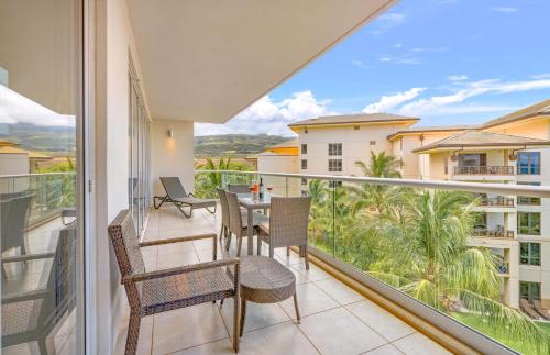 a balcony with chairs and a table with a view at Honua Kai Resort And Spa By Maui Resort Rentals in Lahaina