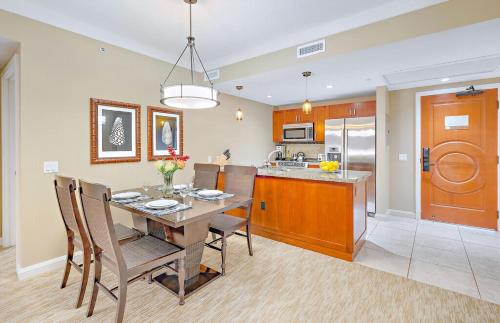 a dining room and kitchen with a table and chairs at Honua Kai Resort And Spa By Maui Resort Rentals in Lahaina