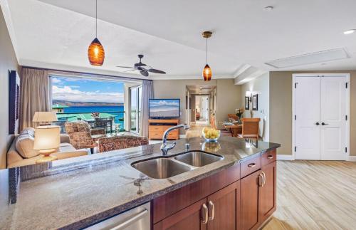a kitchen with a sink and a view of the ocean at Honua Kai Resort And Spa By Maui Resort Rentals in Lahaina