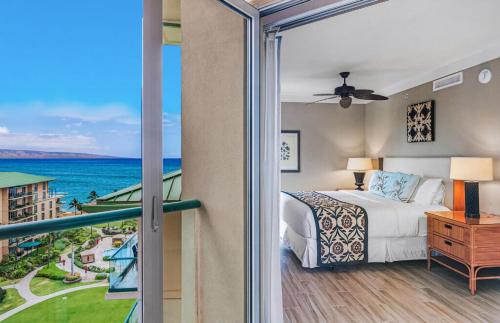 a bedroom with a bed and a view of the ocean at Honua Kai Resort And Spa By Maui Resort Rentals in Lahaina