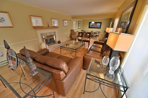 a living room with leather couches and a fireplace at Farmhouse in Hershey in Hershey