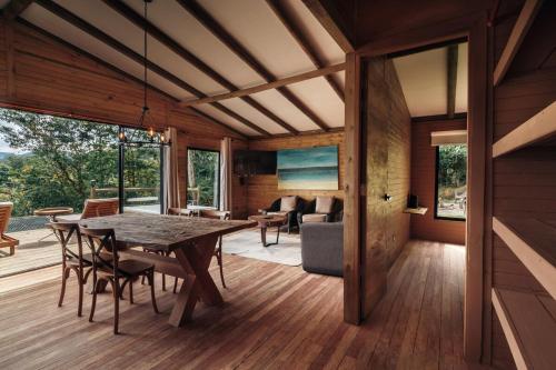 a dining room with a table and a couch at The Ultimate Group House with Jacuzzi and Amazing View in Rionegro