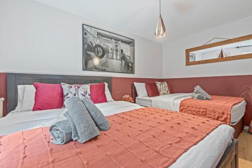 a bedroom with two beds and a mirror at Summer Deals up to 20 Percent OFF! Cosy Central London Family Stay Near Top Attractions - London Bridge & Shard - 3 Nearby Stations & Parking - WiFi & Games! in London