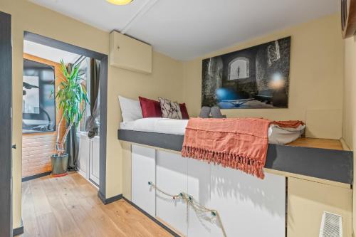 a bedroom with a bed on a wall at Summer Deals up to 20 Percent OFF! Cosy Central London Family Stay Near Top Attractions - London Bridge & Shard - 3 Nearby Stations & Parking - WiFi & Games! in London