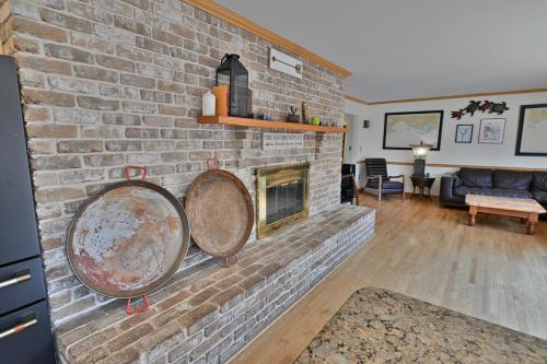 a brick fireplace with two large gongs on it at Farmhouse in Hershey in Hershey