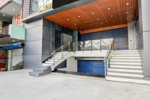 a building with a staircase in front of a building at Super Collection O Hotel Evergreen in Faridabad