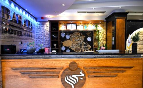 a bar in a restaurant with a sign on it at BARADA Hotel- فندق بردى in Qaryat al Bulush
