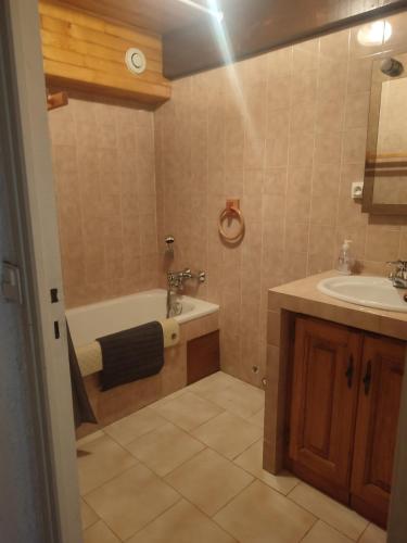 a bathroom with a bath tub and a sink at 3p montagnard proche activité in La Colmiane