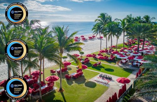 an aerial view of a resort with red umbrellas and the beach at Acqualina Resort and Residences in Miami Beach