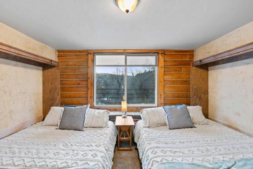 two beds in a room with a window at Evy's Family Ranch Cabin Secluded in Heber City