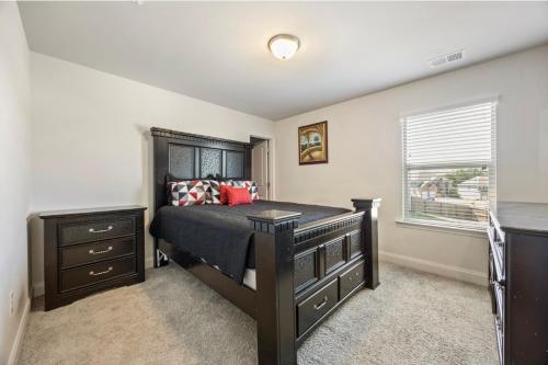 a bedroom with a bed and a dresser and a window at Conyers Place in Conyers