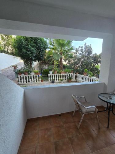 a room with a table and a chair and a balcony at Alpha 2 Rooms in Sarandë