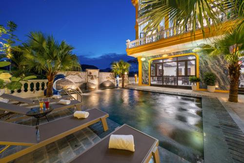 a swimming pool in front of a building at Tam Coc Babylon Hotel in Ninh Binh