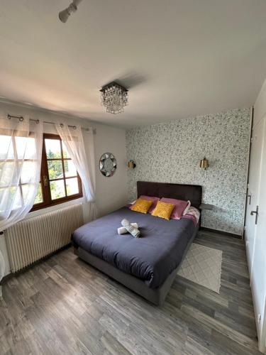 a bedroom with a large bed in a room at Domaine de la Provençale in Saint-Didier-de-la-Tour