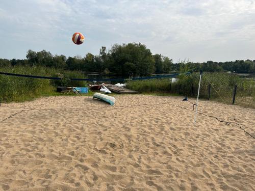 a volleyball ball is flying over a sandy beach at Direkt am See mit privatem Sandstrand in Güster