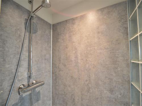 a bathroom with a shower with a glass door at Rochehaut Hideaway with Tub in Rochehaut