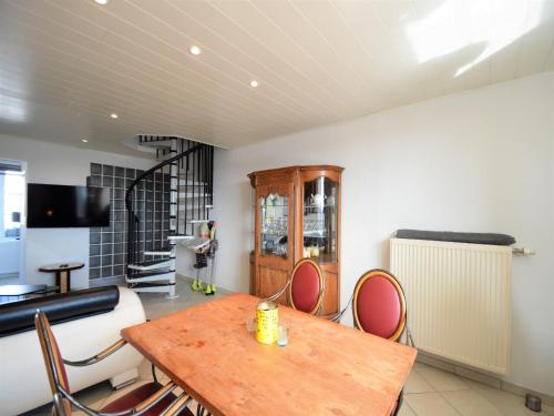 a dining room with a wooden table and chairs at Rochehaut Hideaway with Tub in Rochehaut