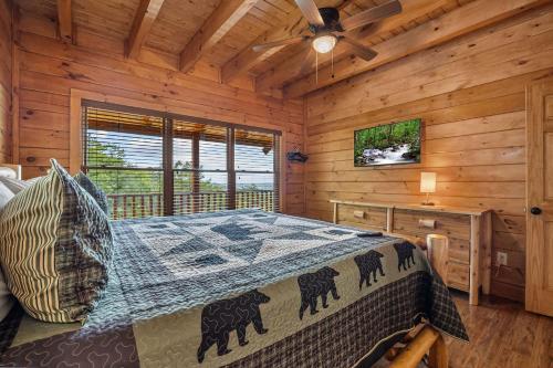 a bedroom with a bed in a wooden cabin at Whataview And Privacy Too by American Patriot Getaways in East Fork