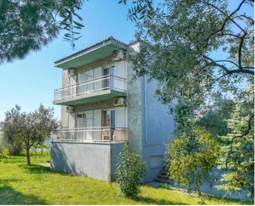 a building with a balcony on the side of it at LaMar in Skala Prinou