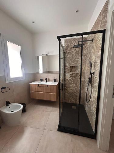 a bathroom with a shower and a toilet and a sink at Wellness House in Bagheria