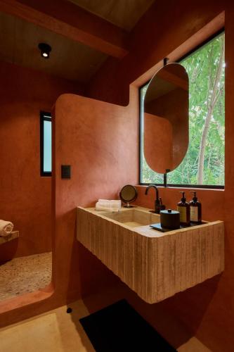 a bathroom with a sink and a mirror at Casa Nadó in Brisas de Zicatela