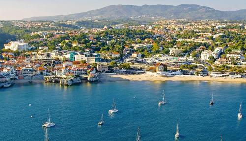 an aerial view of a city with boats in the water at Stays Cascais Portugal in Estoril