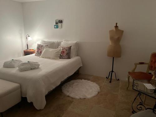 a bedroom with a white bed with a white rug at Maison 1838 