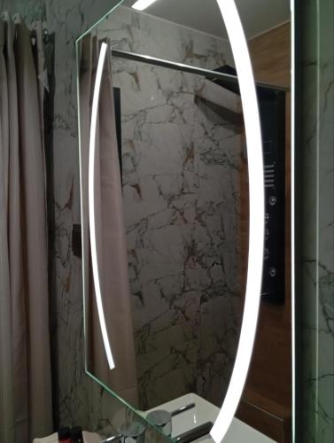 a bathroom with a mirror on a sink at Rosso Verde Apartments in Kókkinon Nerón