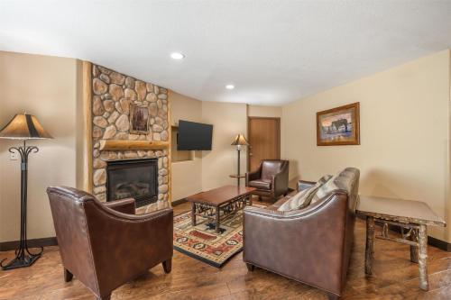 a living room with chairs and a fireplace at Best Western Plus Kelly Inn & Suites in Billings