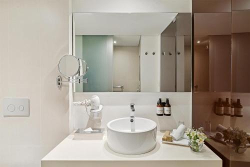a bathroom with a sink and a mirror at NH Collection Mexico City Reforma in Mexico City
