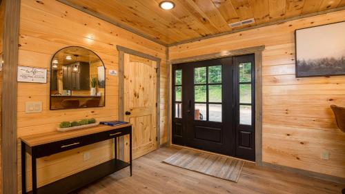 a room with a black door and a mirror at Swish Splash Lodge by American Patriot Getaways in Cartertown